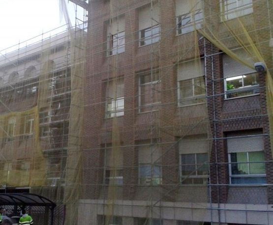 Un gran edificio de ladrillo con andamios a su alrededor.