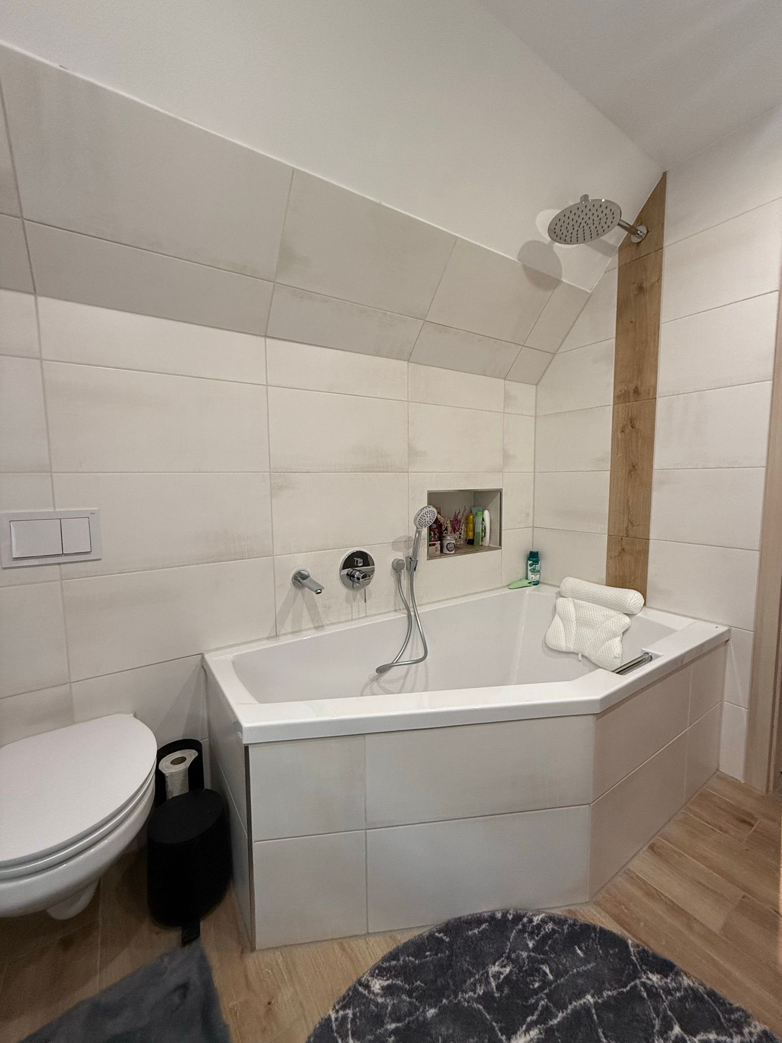 Ein Badezimmer mit Badewanne, Toilette und Teppich.