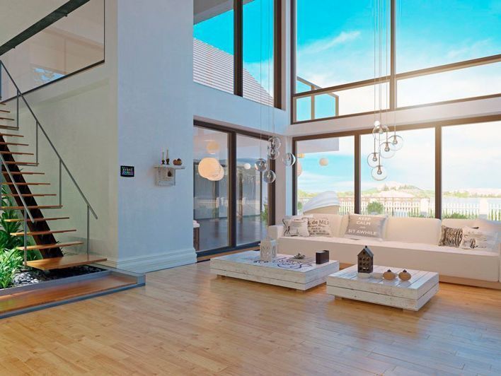 Una sala de estar con un sofá, dos mesas de café y una escalera.