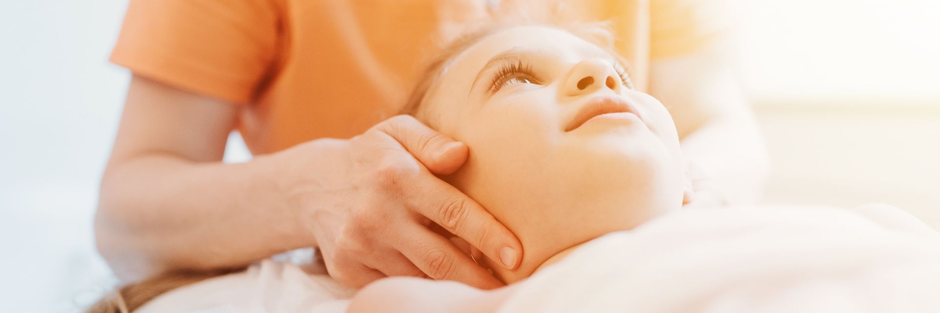 Enfant recevant des soins d'ostéopathie pédiatrique