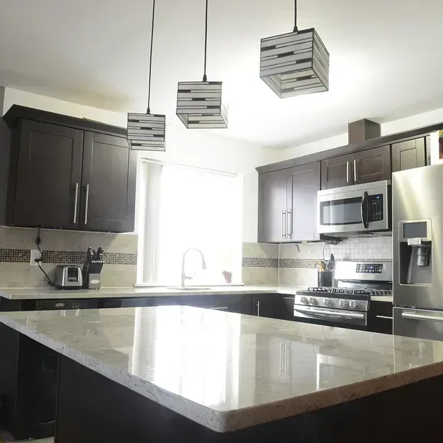 Una cocina con electrodomésticos de acero inoxidable y una gran isla.