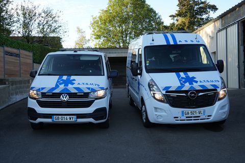 Une main ouvre la portière d'une voiture noire près du siège arrière.