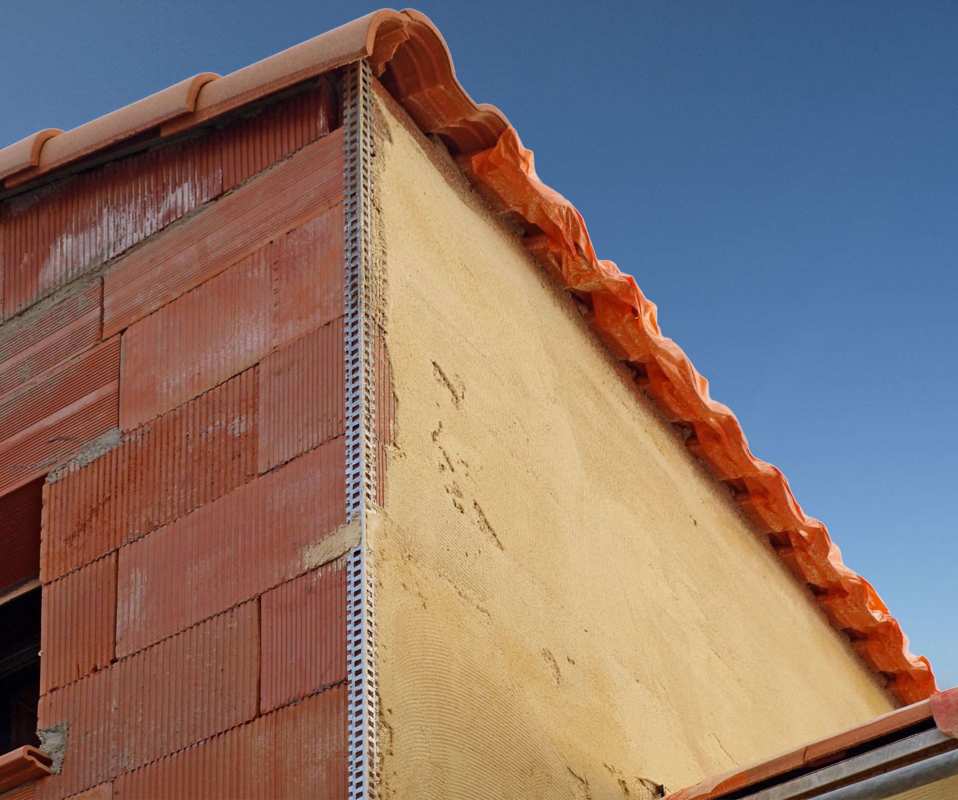 Bâtiment en briques rouges et un toit en tuiles orange.