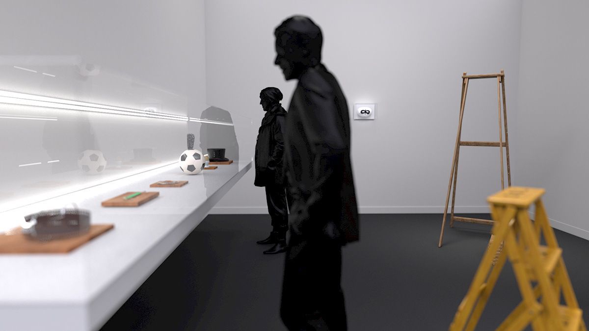 Dos siluetas observan la exposición en una galería. Un largo estante blanco contiene objetos.