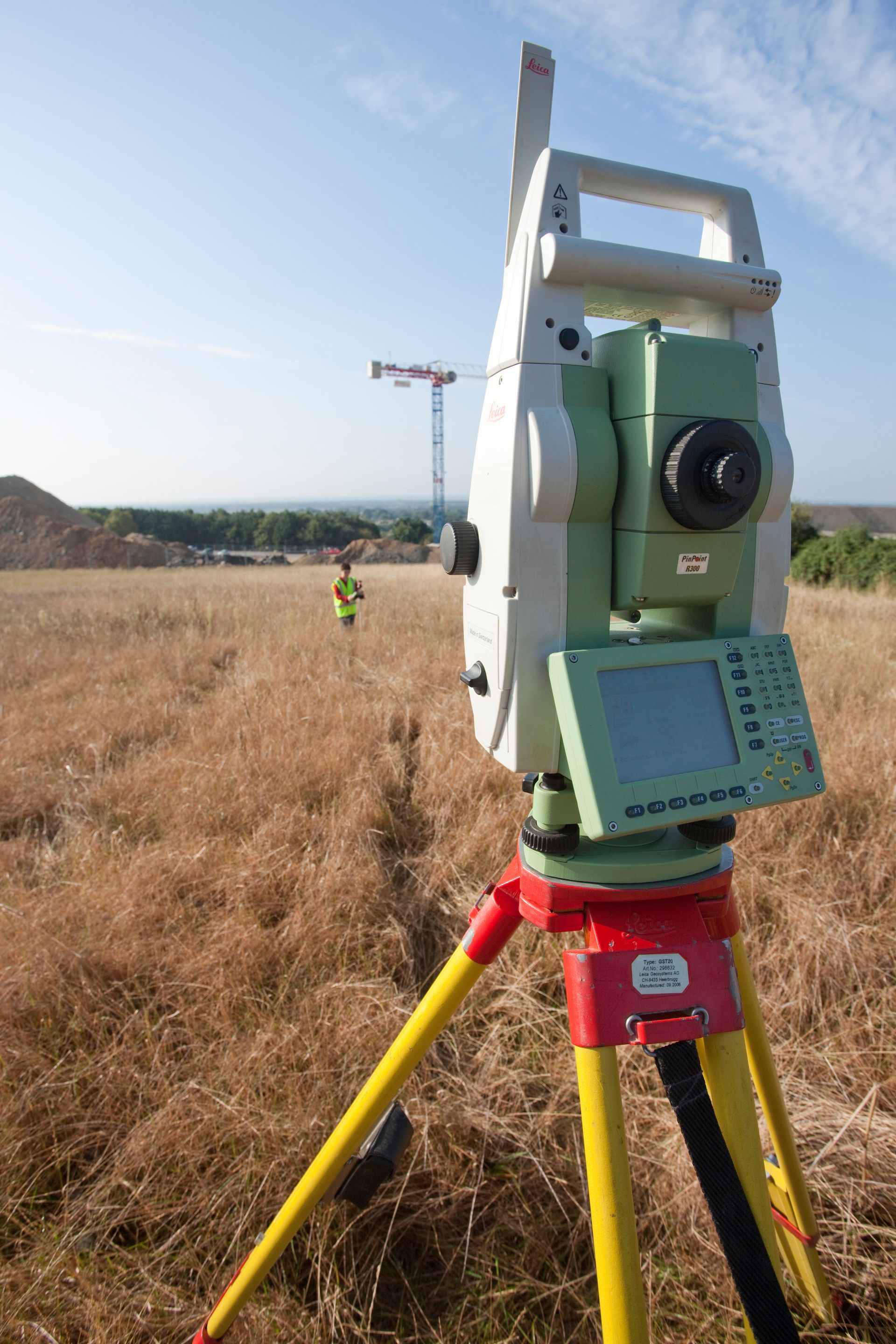 Tachéomètre  avec un géomètre au fond