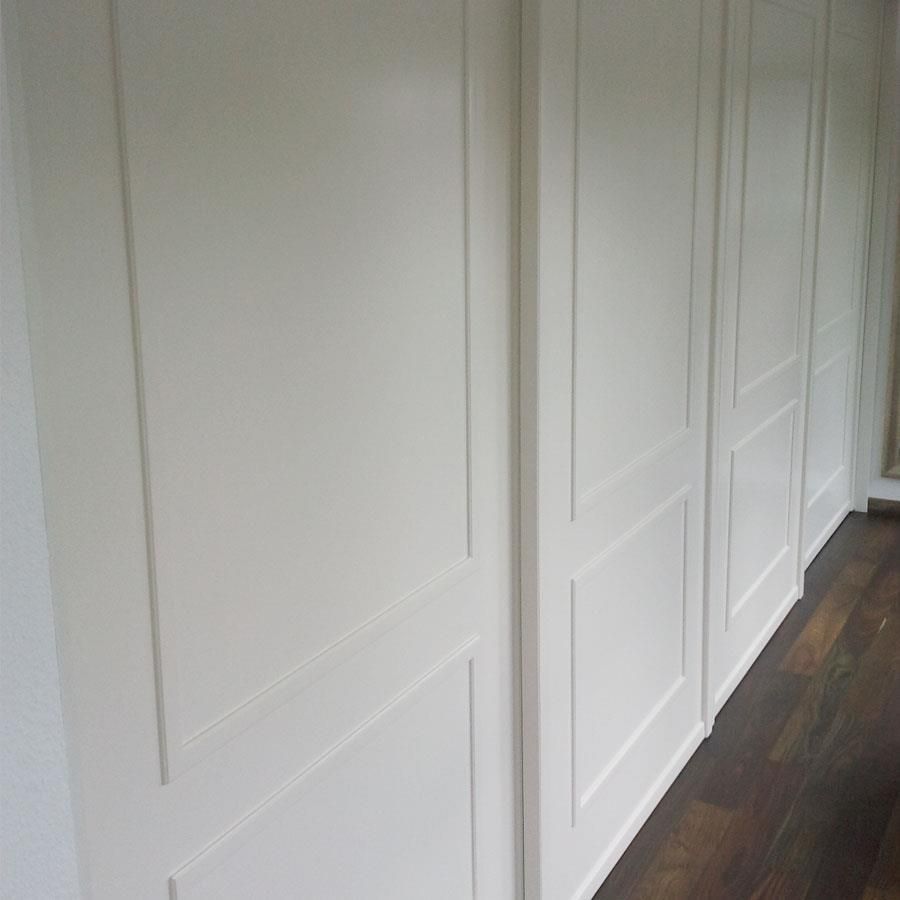 Ein Flur mit weißen Wänden und Holzboden.