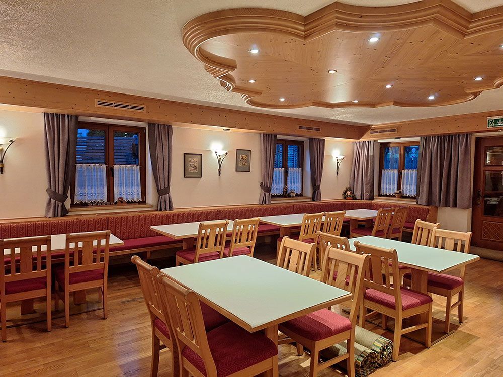 Ein Restaurant mit Tischen und Stühlen und einer Holzdecke