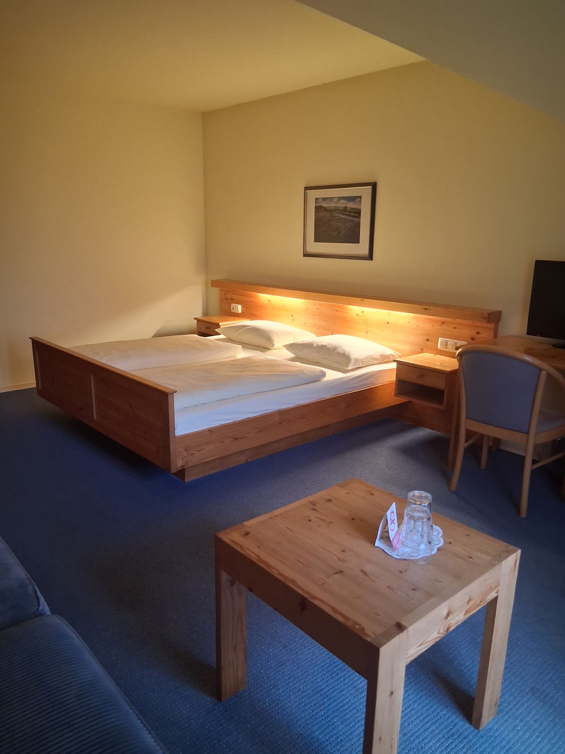 Hotelzimmer mit zwei Einzelbetten, Meerblick, Schreibtisch und Loungesessel.