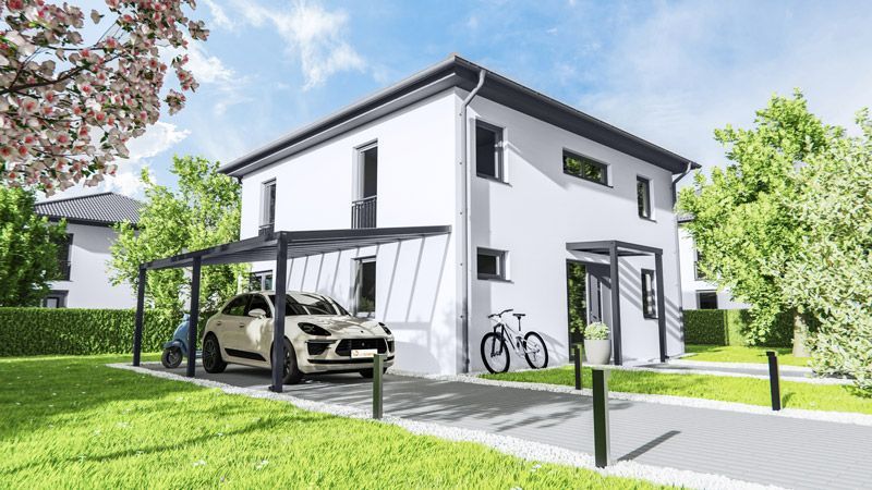 Ein Auto ist unter einem Vordach vor einem weißen Haus geparkt.