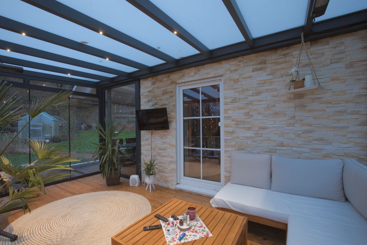 Ein Wohnzimmer mit Couch, Tisch und Fernseher.