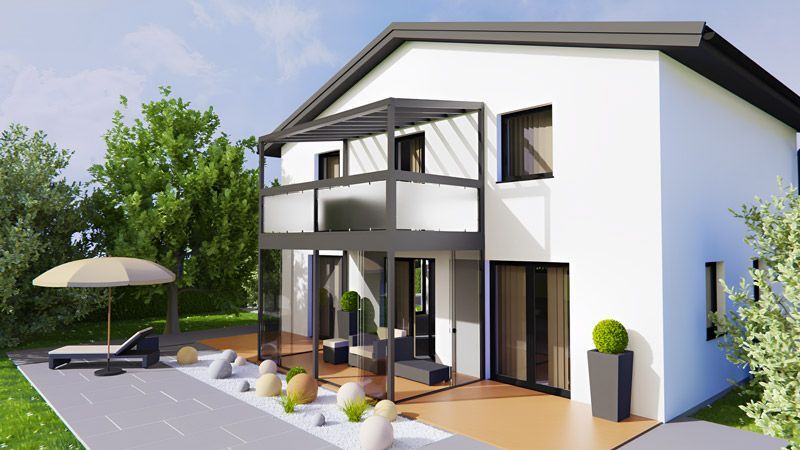 Ein weißes Haus mit einer Terrasse und einem Sonnenschirm davor