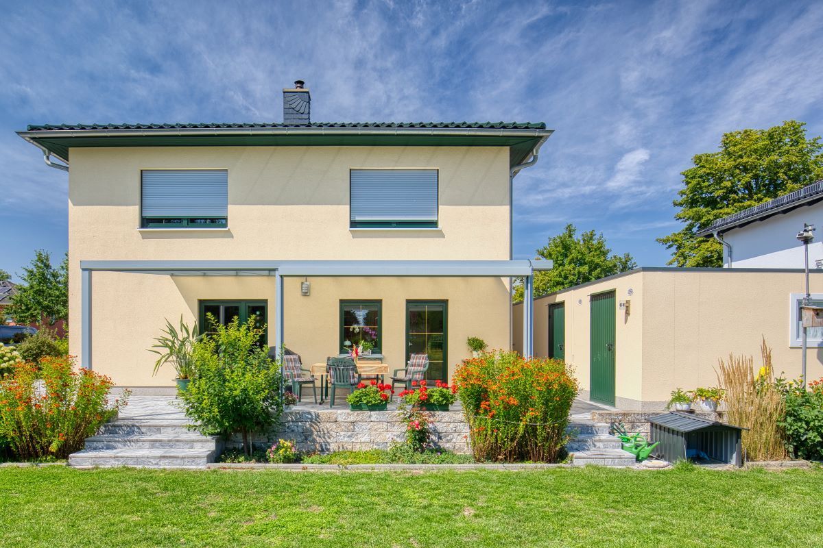 Ein großes Haus mit einer großen Wiese davor.