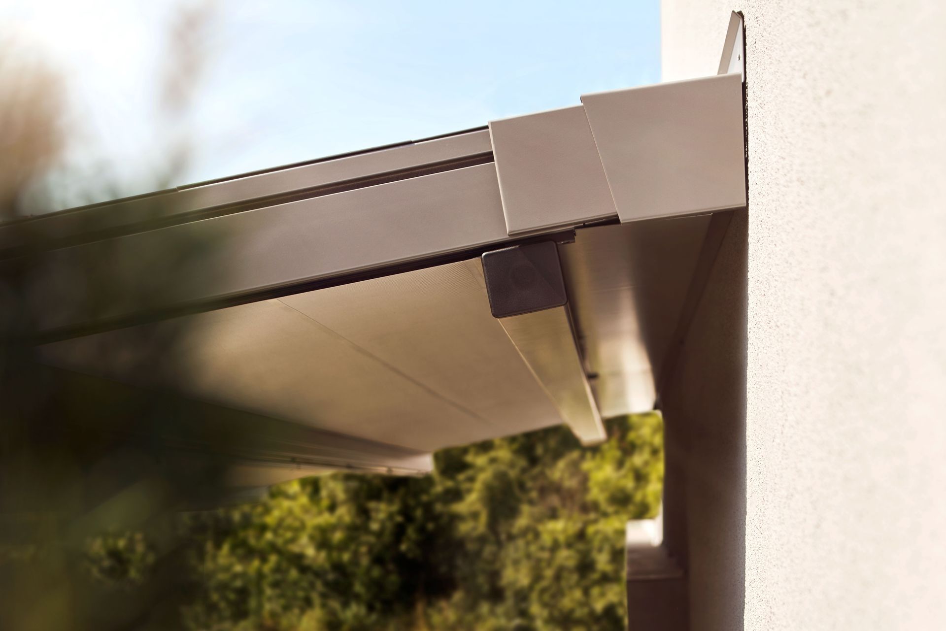 Eine Nahaufnahme eines Gebäudedachs mit Bäumen im Hintergrund.