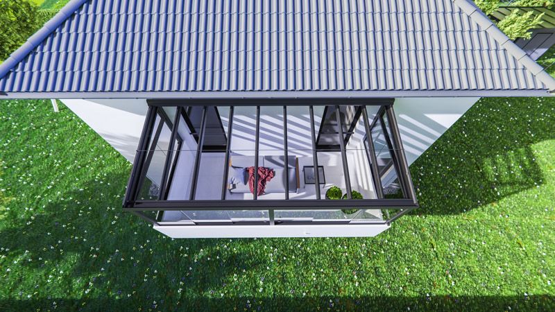 Eine Luftaufnahme eines Hauses mit einem Dach, das von Gras umgeben ist.