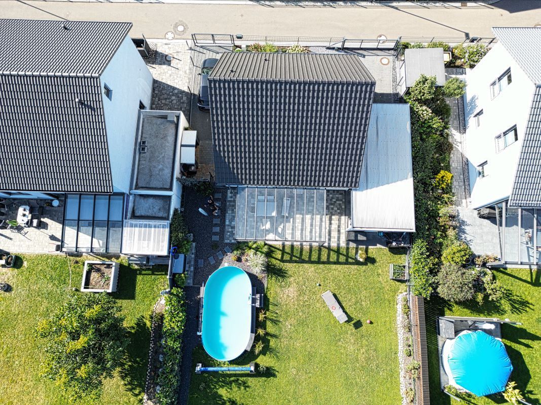 Eine Luftaufnahme eines Hauses mit einem Swimmingpool im Hinterhof.