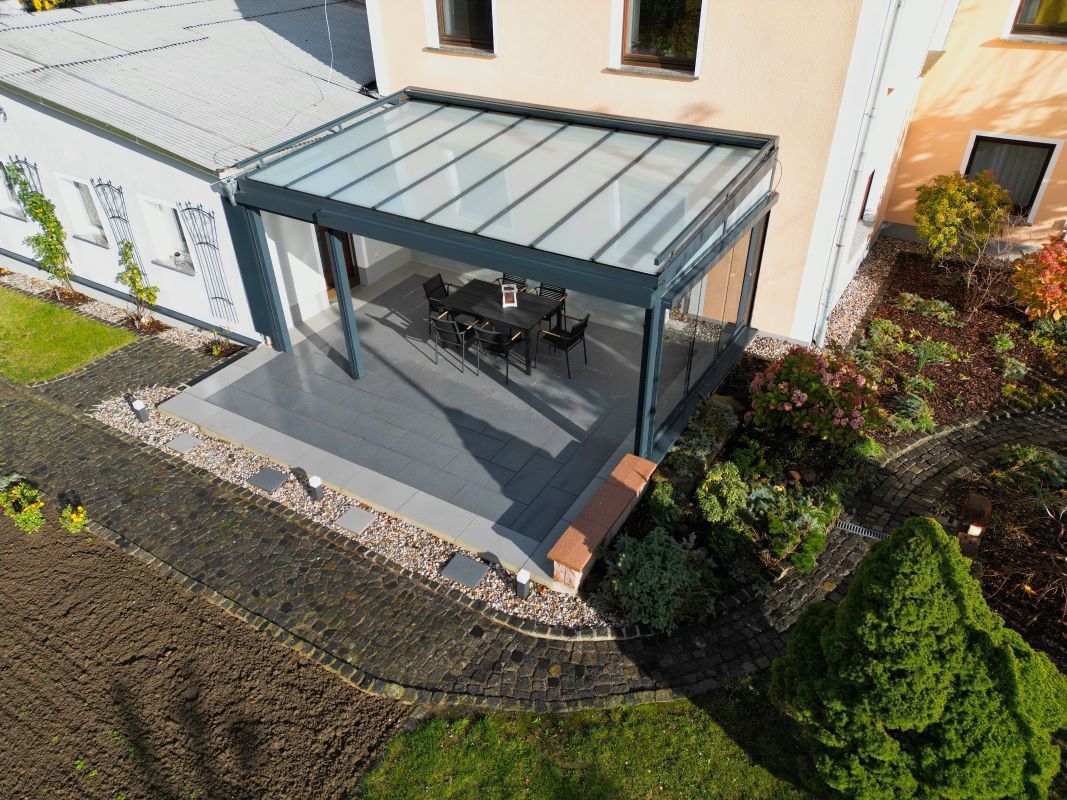 Eine Luftaufnahme eines Hauses mit Glasdach und Terrasse.
