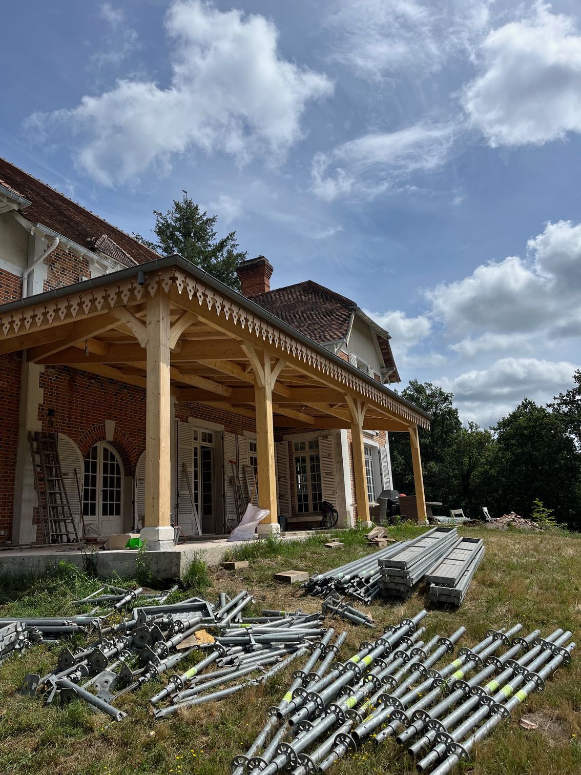 Varangue installée pour une maison traditionnelle avec les équipements du chantier sur la pelouse