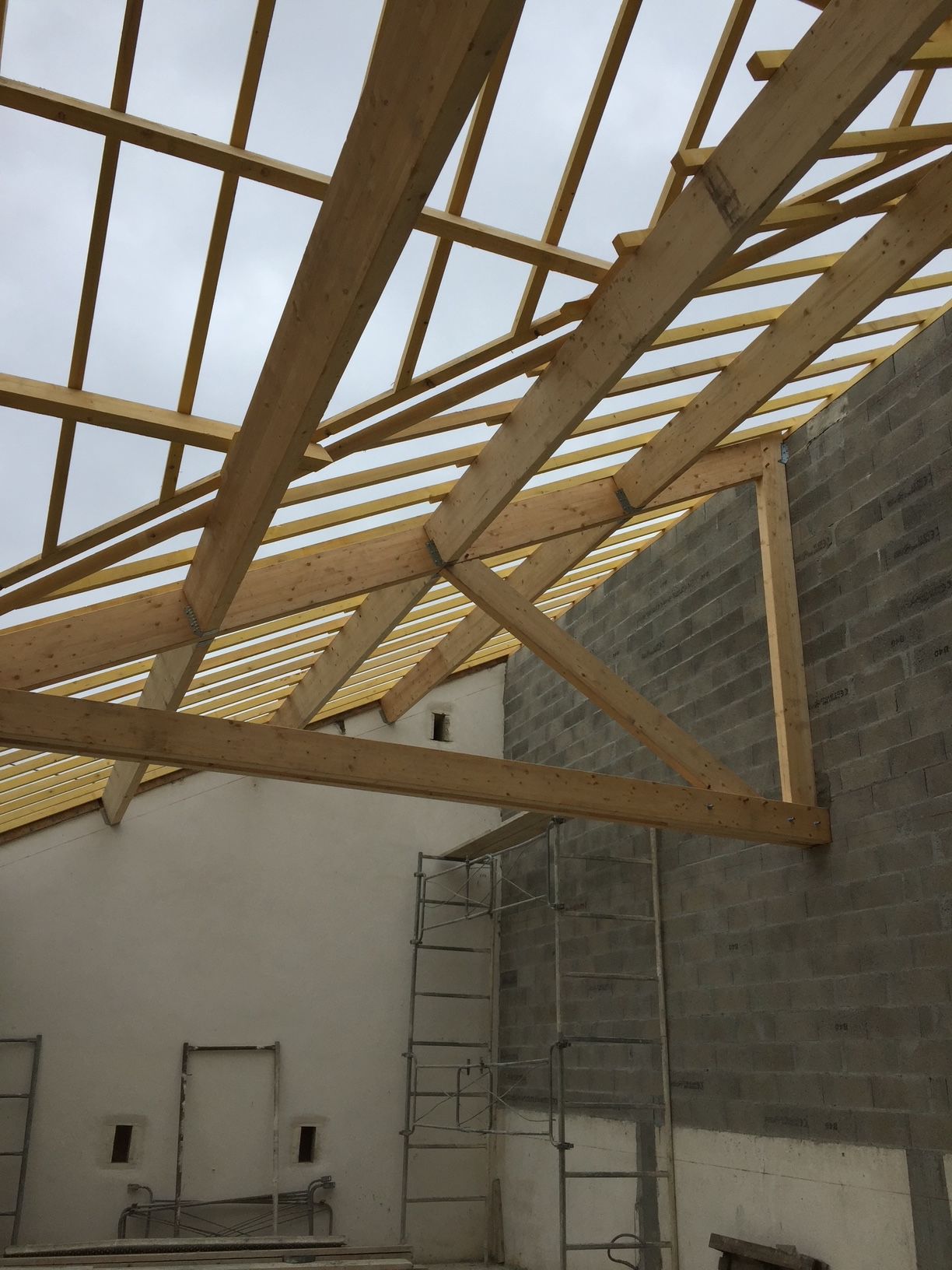 Chantier de construction d'une maison avec les murs élevés et la charpente posée