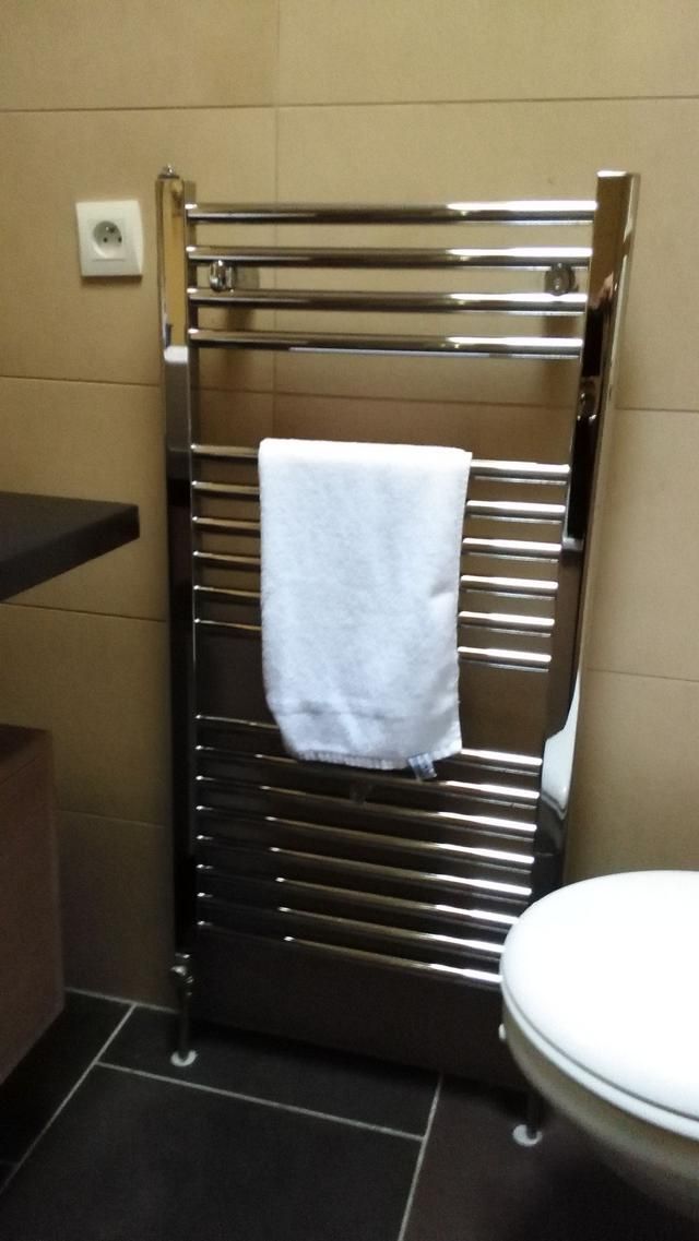 Sèche-serviettes chromé avec serviette blanche