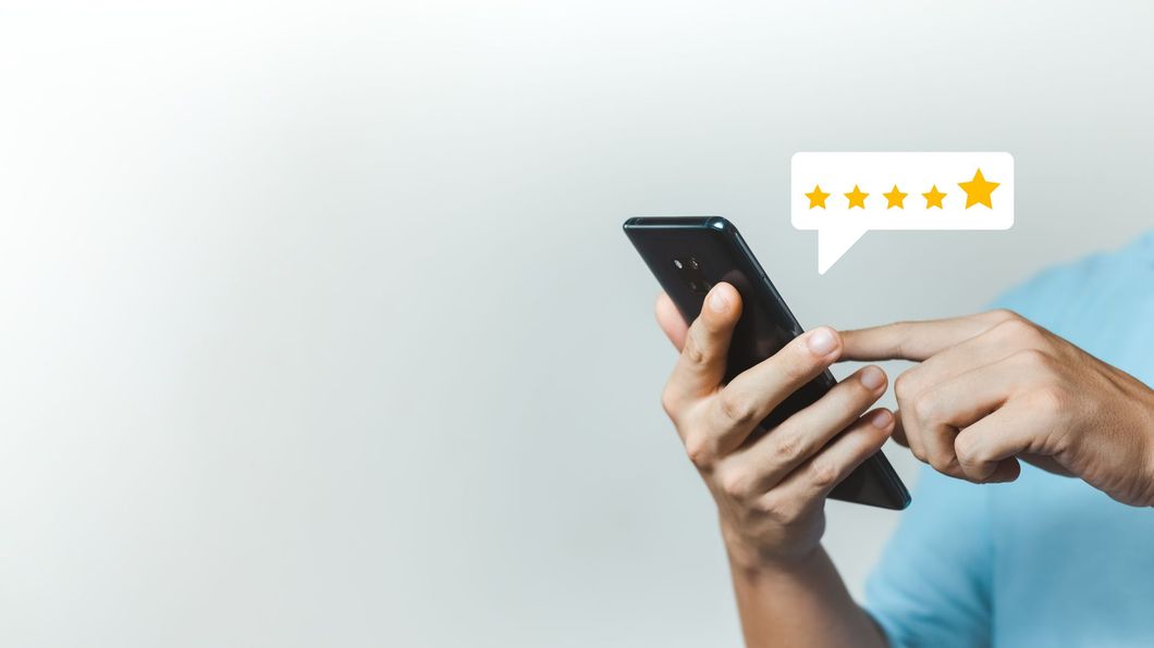 Eine Person gibt eine Bewertung über ein Mobiltelefon ab.