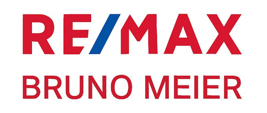 Das RE/MAX-Logo: Rote Buchstaben mit einem blauen schrägen „i“ in der Mitte.