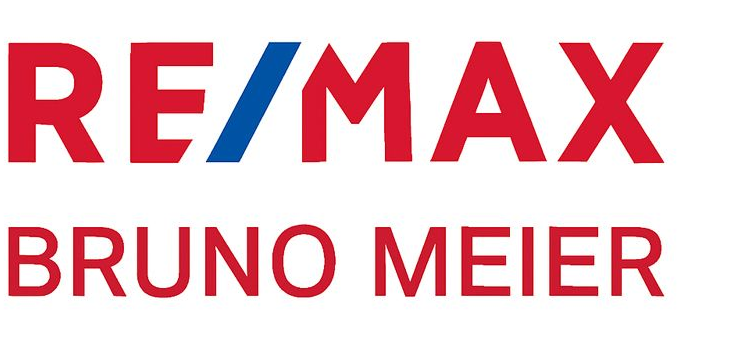 Das RE/MAX-Logo: Rote Buchstaben mit einem blauen schrägen „i“ in der Mitte.