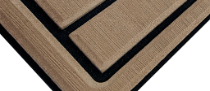 Nahaufnahme einer beige-schwarzen, geschichteten Ecke, ähnlich einer Passepartout- oder Rahmenkante.