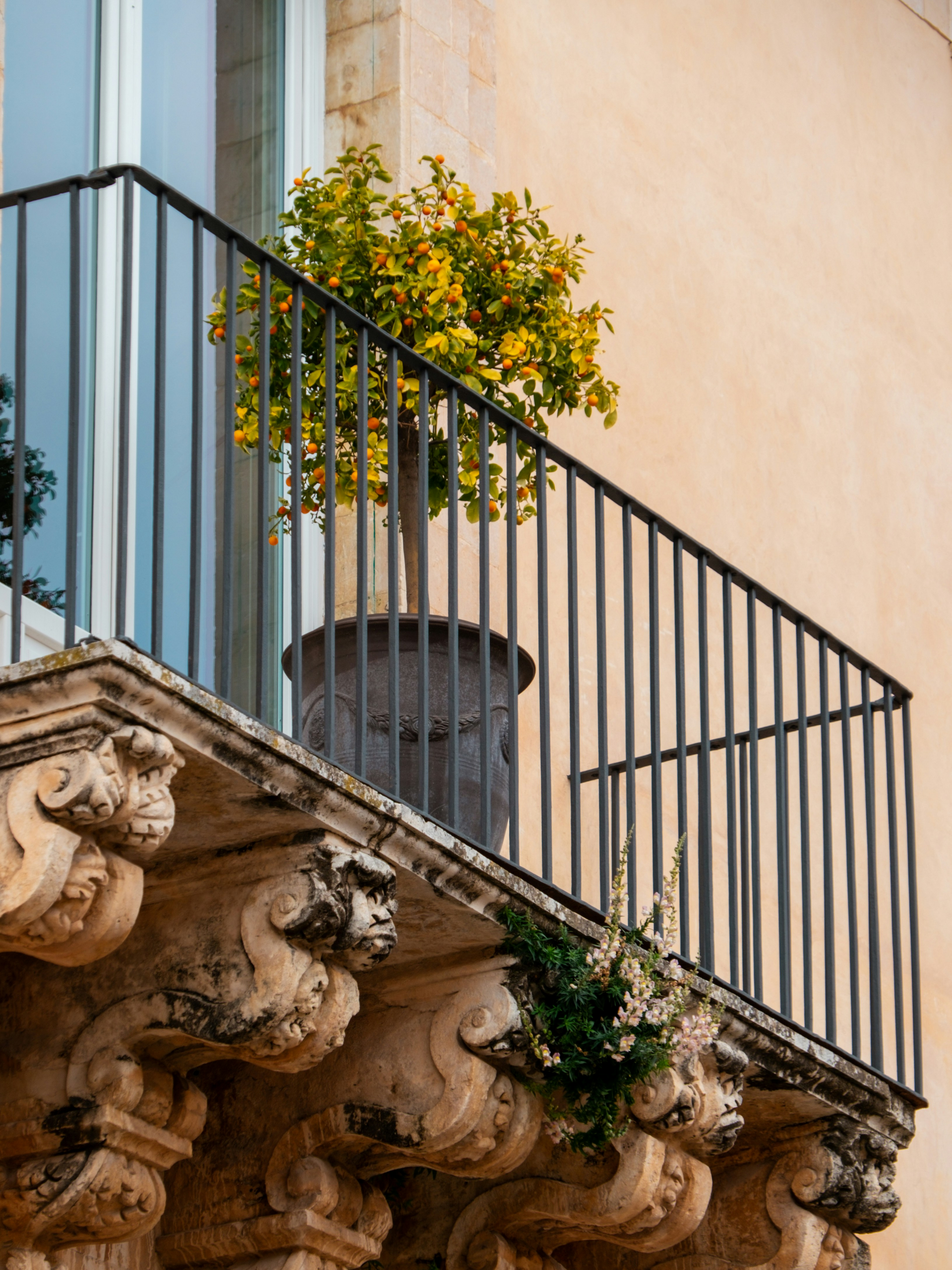 Holiday apartment balcony in Noto Sicily with potted tree and Mediterranean outdoor living atmosphere