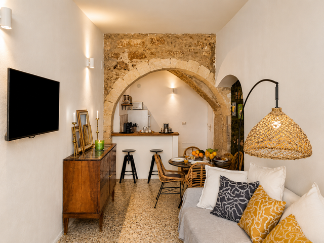 Cozy living area at Aura Stay Noto Centro featuring a comfortable sofa, decorative cushions, and stylish interior design