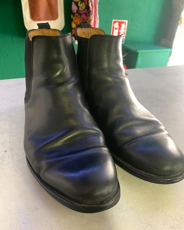 Bottines en cuir noir sur une surface claire, présentées côte à côte.