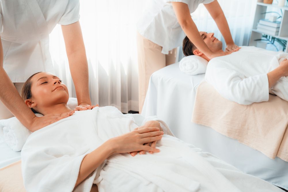 Un hombre y una mujer están recibiendo un masaje en un spa.