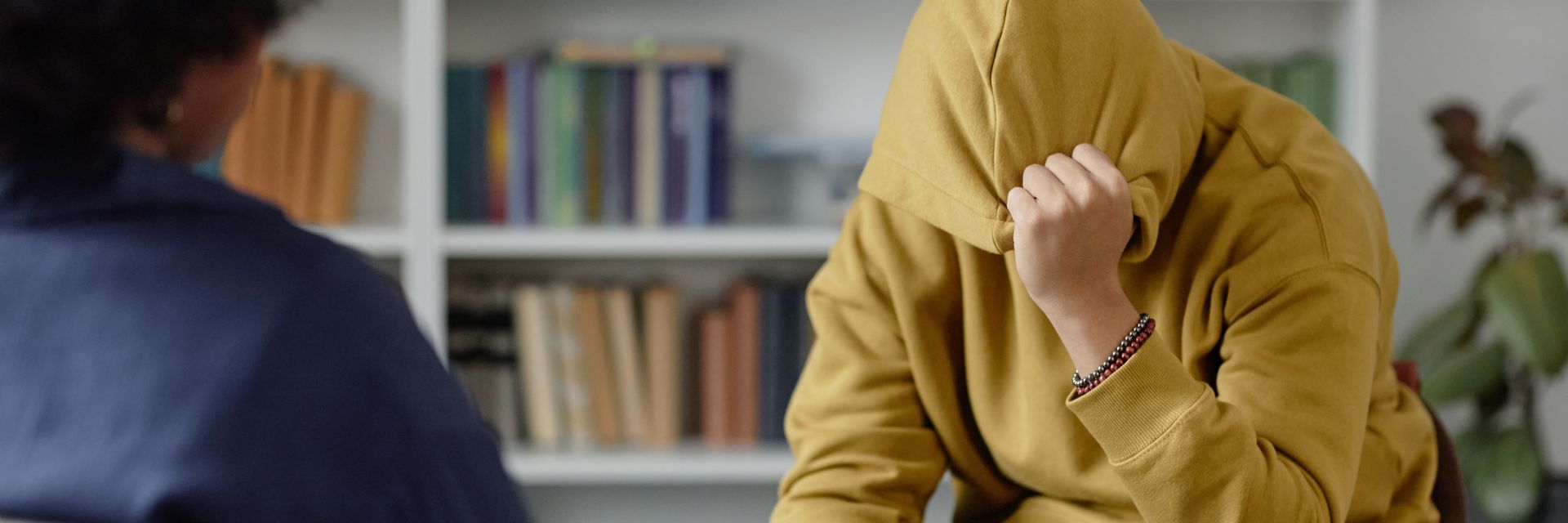 Un jeune tenant sa capuche