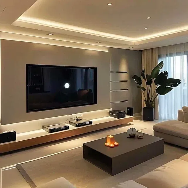 Una sala de estar con un televisor de pantalla plana grande en la pared.