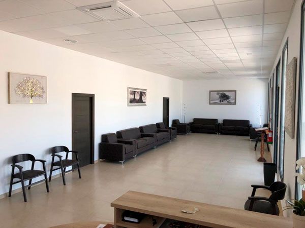 Una habitación larga con muchos muebles y sillas.