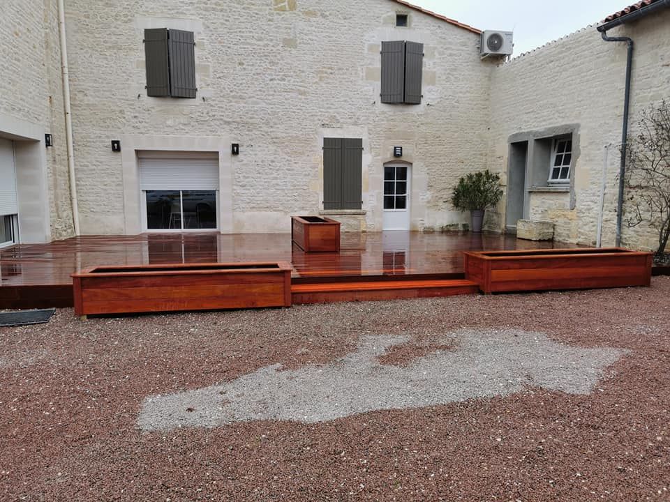 Une terrasse en bois exotique devant une maison ancienne