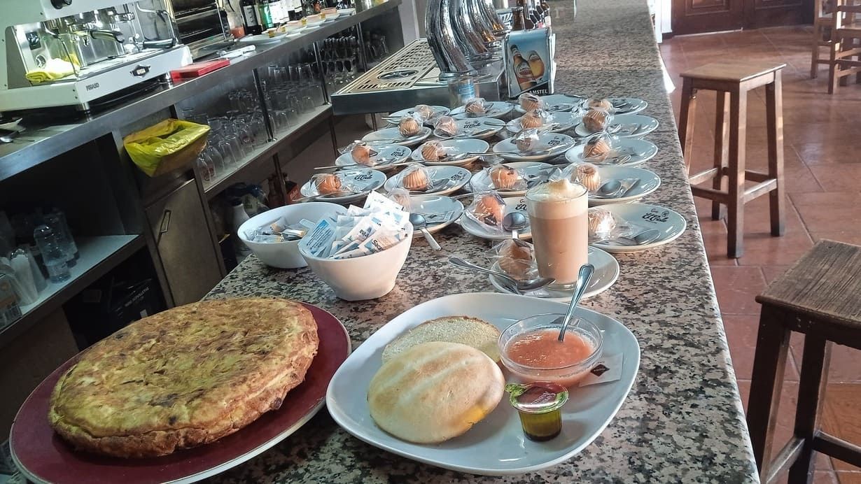 Una mesa con platos de comida y salsas sobre ella.