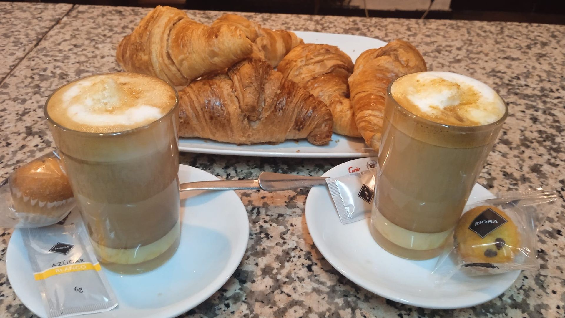 Dos tazas de café y croissants en una mesa