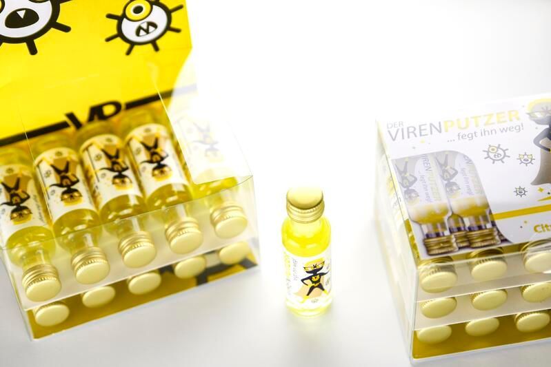 Eine Schachtel mit Pillen neben einer Flasche mit Pillen auf einem Tisch.