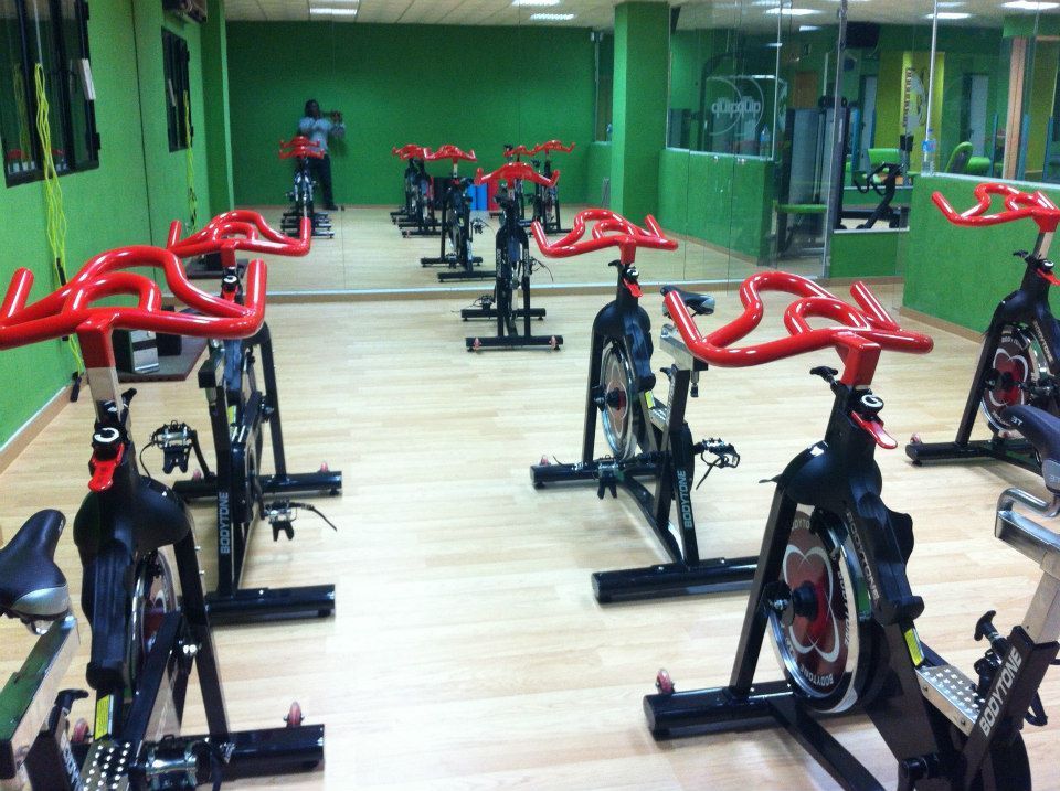 Un estudio de ciclismo indoor con varias bicicletas estáticas con manillares 