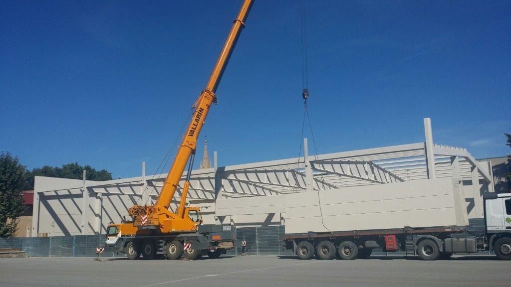 Se está utilizando una gran grúa amarilla para levantar un edificio.