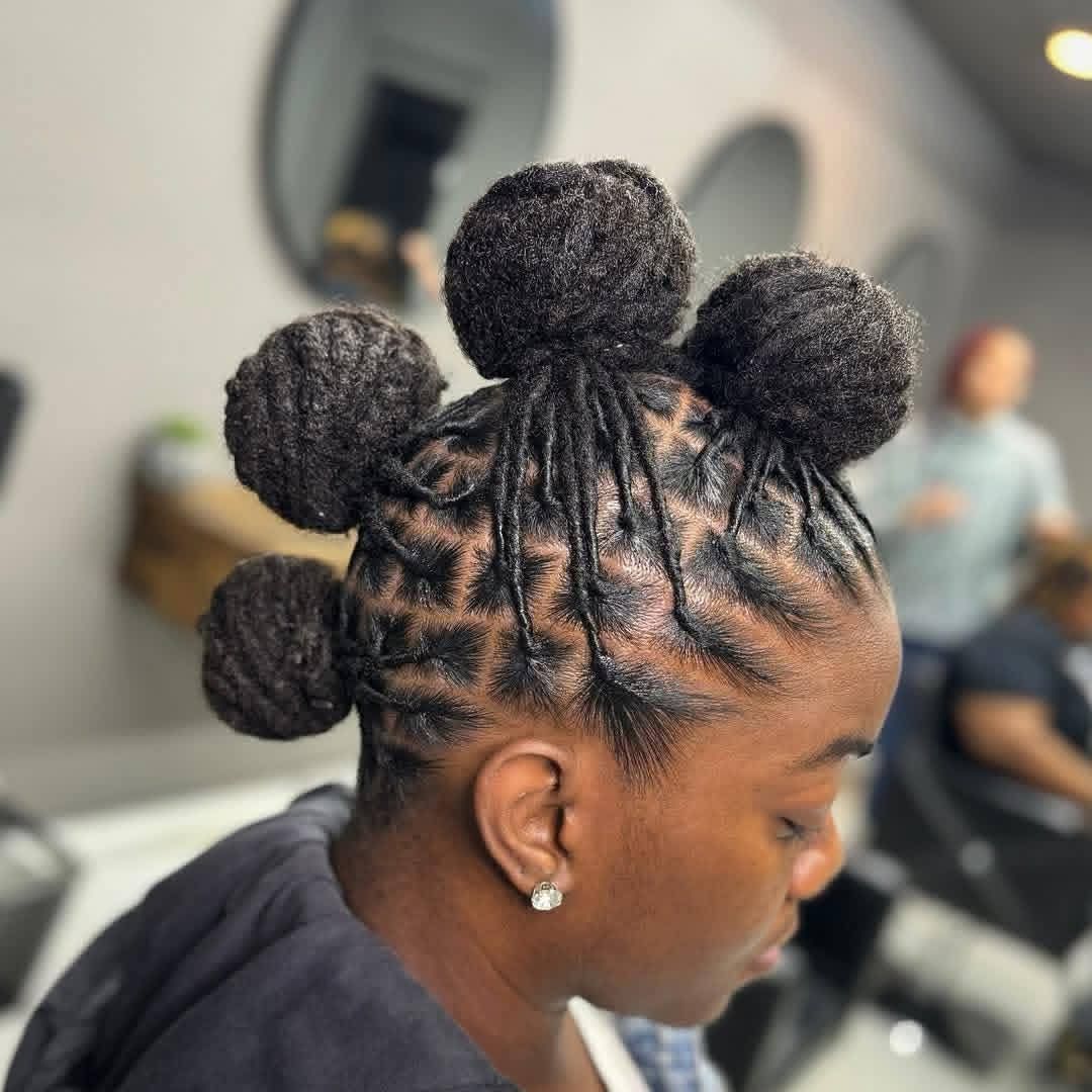 Coiffure tressée avec quatre chignons bouffants, vue de profil sur une chaise de salon