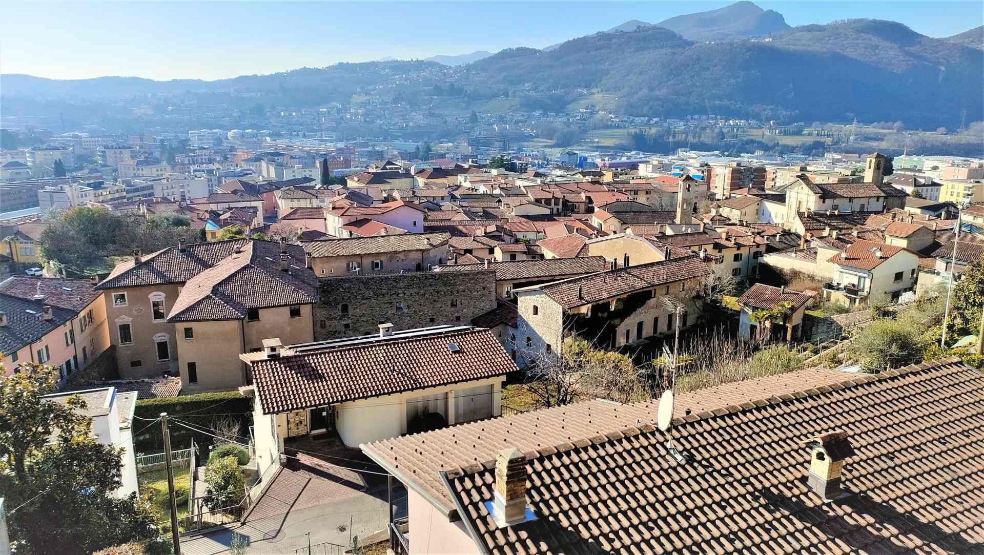 Una vista aerea di una città con le montagne sullo sfondo.