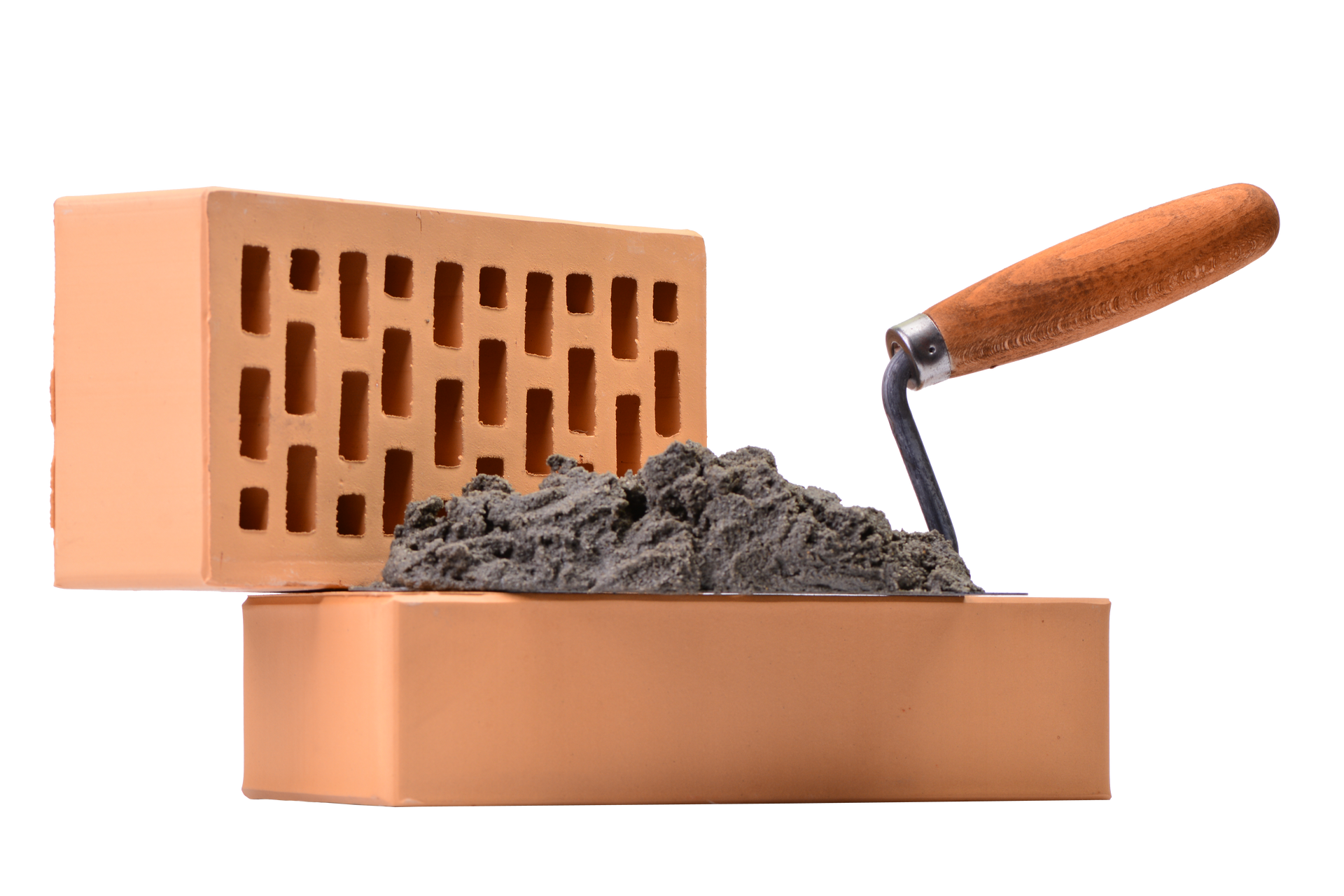 Une truelle contenant une pelletée de mortier repose sur une brique orange pleine.