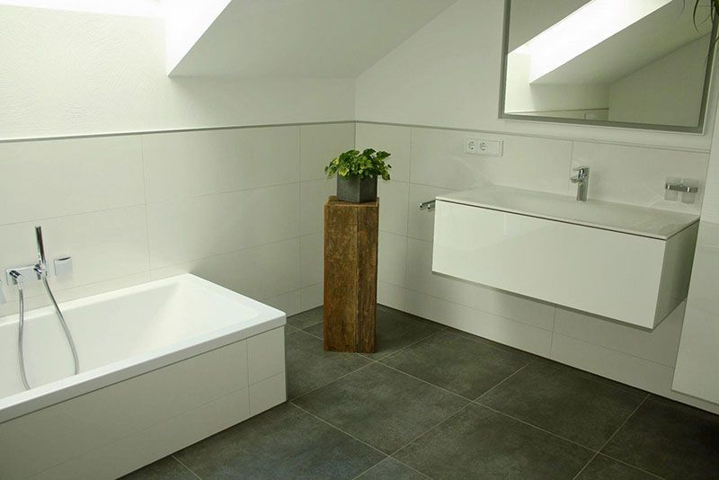 Ein Badezimmer mit Badewanne, Waschbecken und Spiegel.