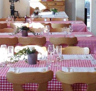 Ein Teller mit Croissants, aus einem davon wurde ein Biss herausgeschnitten, auf einem Holztisch.