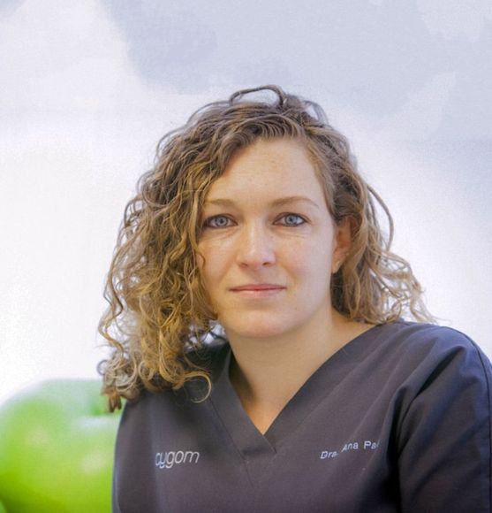Una mujer que lleva una blusa médica con el nombre Agam escrito en ella.