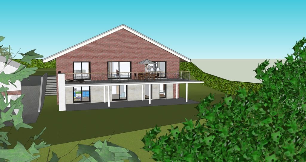 Maison en briques de deux étages, à la structure blanche, soutenue par des piliers, sur un coteau herbeux. Des arbres encadrent la vue.