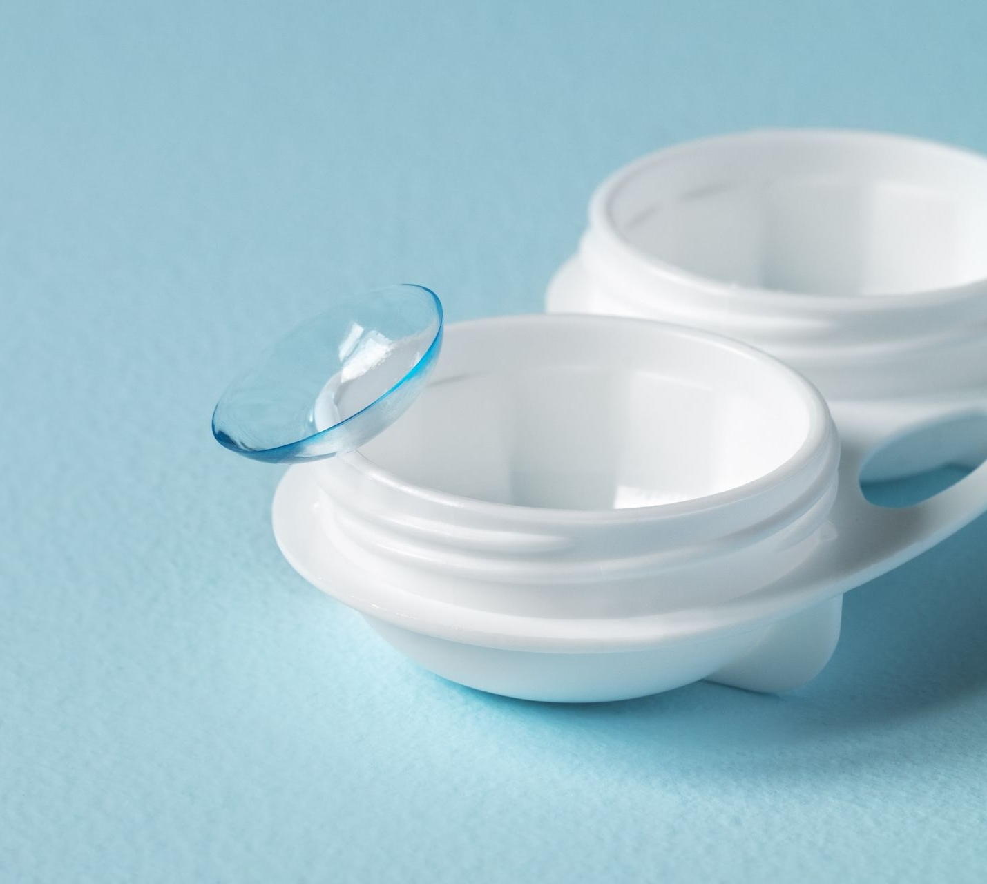 Lentille de contact à côté de son étui de rangement.