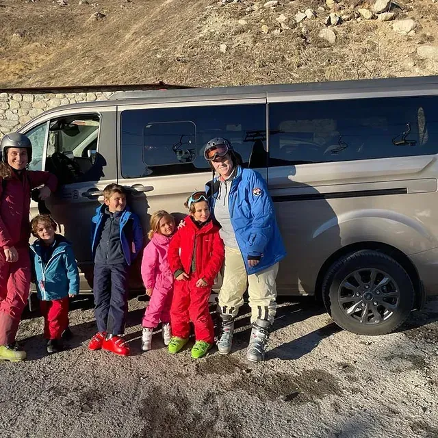 Un grupo de personas posando para una foto frente a una camioneta.