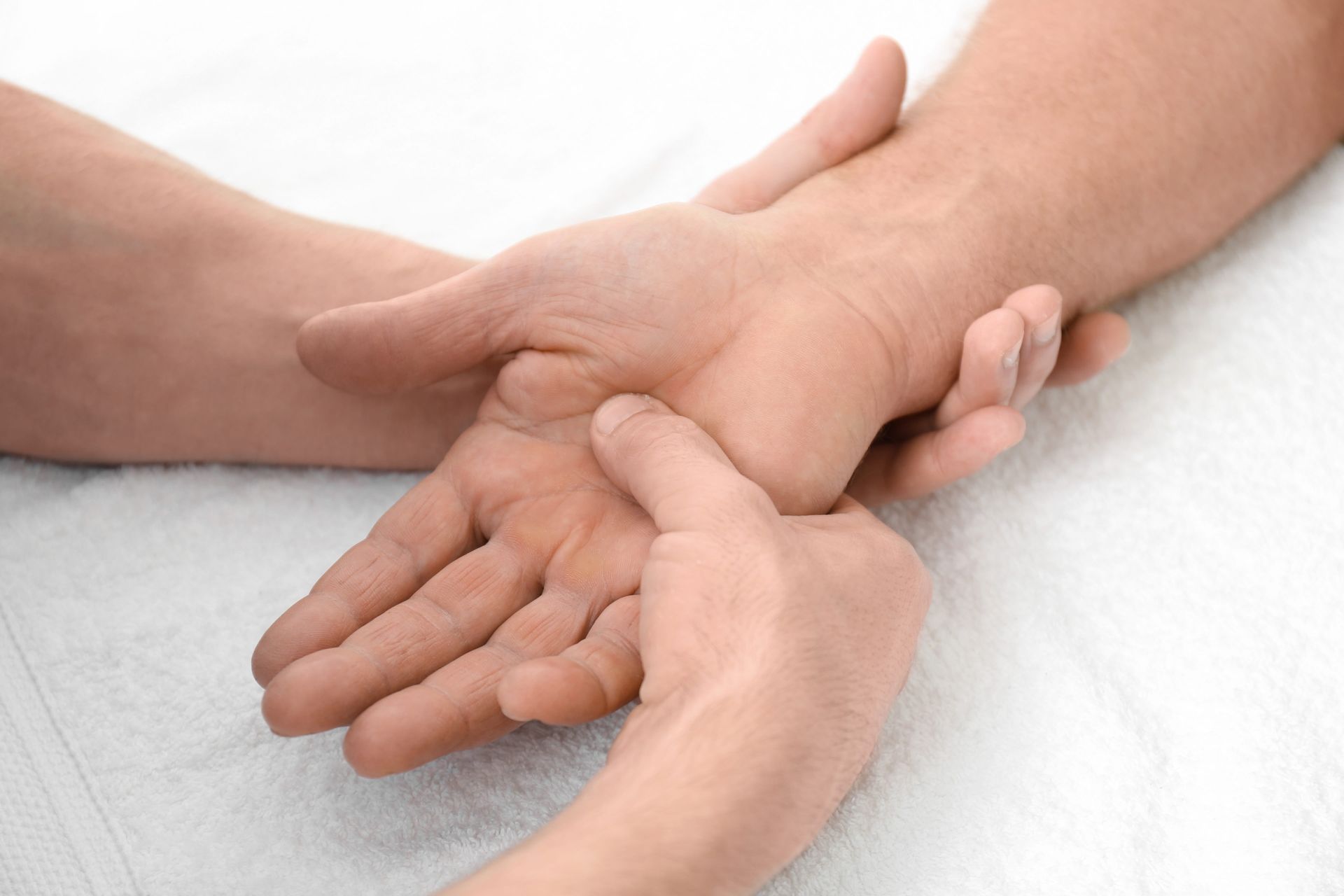 Mains jointes en signe de soutien sur une surface blanche